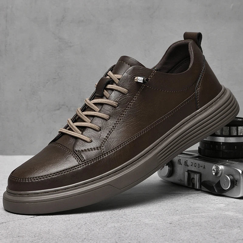 Pair of men's white low-top sneakers angled on a plain background