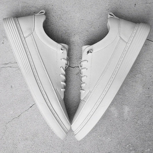 Pair of men's white leather low-top trainers on a white background